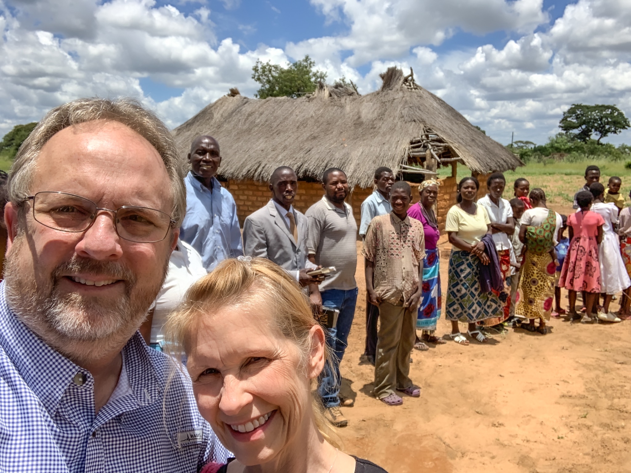 Ken and Karen with Zambian church members and families near a village church