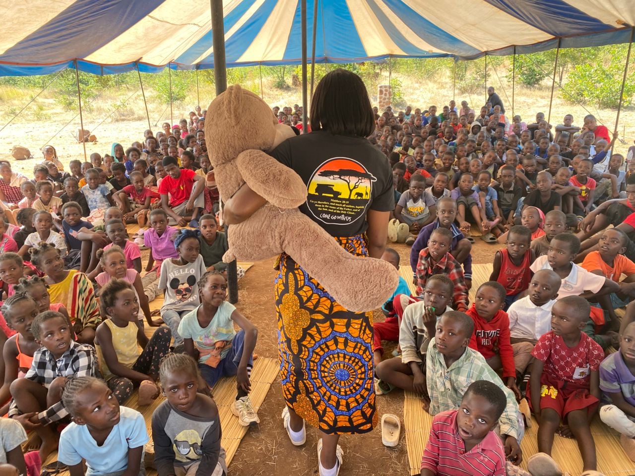 Bertha seated with a teddy bear during a Good News Club activity